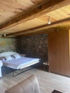 a bedroom with a bed and a wooden ceiling at Konak Vrela Žabljak in Žabljak