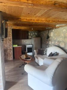 a living room with a white couch and a table at Konak Vrela Žabljak in Žabljak +27 photos