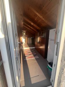 a hallway leading to a kitchen with a door open at Konak Vrela Žabljak in Žabljak