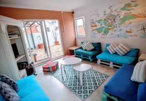 a living room with blue couches and a table at Orange3 Hostel in Lagos