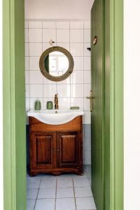 a bathroom with a sink and a mirror at Stellinas House 2 in Andros