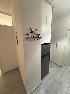a kitchen with white walls and a stove at Marina in Shëngjin +3 photos