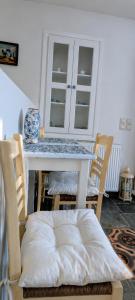 a dining room table with chairs and a table with a counter at Stellinas House 2 in Andros