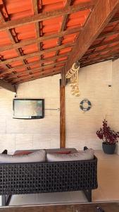 a living room with a couch and a wall at Moreno Guest House com Piscina, churrasqueira Praia de Itaguaré e Riviera in Bertioga