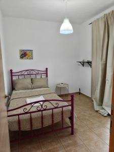 a bedroom with a purple bed in a room at Eveline house in Larisa