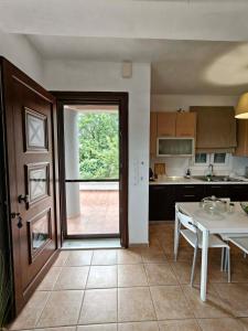 a kitchen with a door open to a kitchen with a table at Eveline house in Larisa