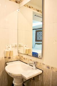 a bathroom with a sink and a mirror at Ha Noi Capital Boutique Hotel in Hanoi +28 photos