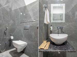a bathroom with a toilet and a sink and a shower at Treebo Ayodhya Grand in Madnāpur