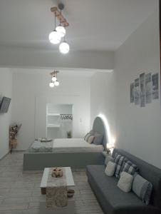 a living room with a bed and a couch at Nikolas Aggelis rooms in Pera Gyalos
