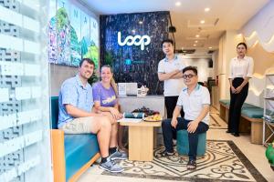 a group of people posing for a picture in a store at Ha Noi Capital Boutique Hotel in Hanoi