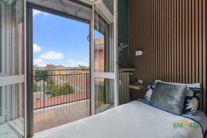 a bedroom with a bed and a balcony with a view at MILANO Bicocca Niguarda a 15min dal DUOMO in Milan