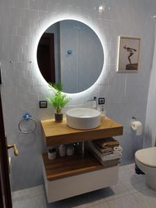 a bathroom with a sink and a mirror at Apartamento El Ferial in Sarón +9 photos