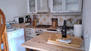 a kitchen with a table with wine glasses on it at Apartment Tacoma in Vrsar