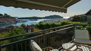 a balcony with chairs and a view of a harbor at Apartment Tacoma in Vrsar
