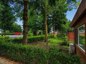 a yard with trees and bushes next to a house at Hipodruma Resort & Pool in Dobrich +17 photos