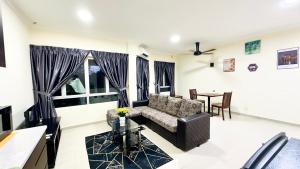a living room with a couch and a table at Desaru Coastline Cribs in Bandar Penawar