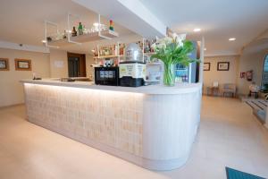 Eine Bar mit einer Blumenvase auf dem Tresen in der Unterkunft Hotel Bersoca in Benicàssim + 57 Fotos