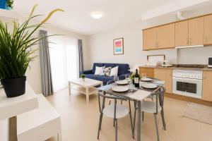 a kitchen and living room with a table and chairs at OPEN SKY VALLEY in Mogán