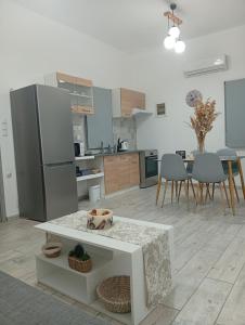 a kitchen and dining room with a table and a refrigerator at Nikolas Aggelis rooms in Pera Gyalos