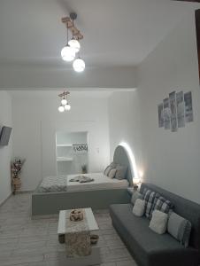 a living room with a bed and a couch at Nikolas Aggelis rooms in Pera Gyalos