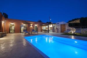 a swimming pool in front of a house at night at Stavlos Villa - Private Pool in episkopi-heraklion