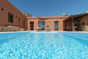 a large swimming pool in front of a house at Stavlos Villa - Private Pool in episkopi-heraklion +114 photos