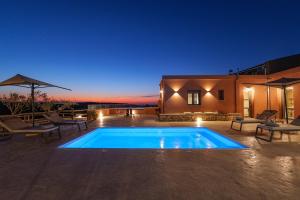 a swimming pool in front of a house at night at Stavlos Villa - Private Pool in episkopi-heraklion