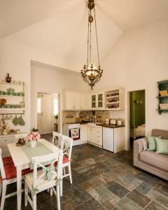 a kitchen and living room with a table and chairs at Stellinas Pretty House in Andros
