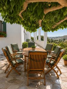 a group of chairs and a table on a patio at Stellinas Pretty House in Andros