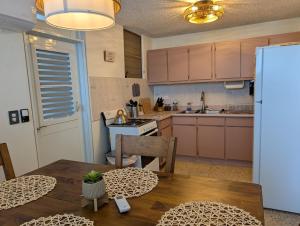 a kitchen with a wooden table and a dining room at Sun Seekers Retreat 3 bedrooms in Santa Maria