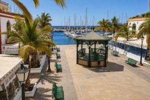a gazebo next to a marina with boats at OPEN SKY VALLEY in Mogán