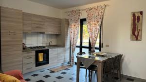a kitchen with a table and a dining room at Casa Vacanza Demetra in Marina di Fuscaldo