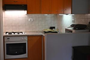 a kitchen with a stove and a counter top at Apartma Kukč II in Bovec