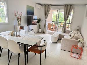 a living room with a table and a couch at New,mountain & sea view 3 guests with private Garage in Beausoleil