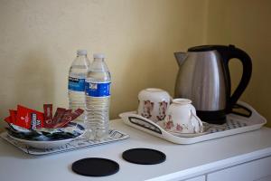 a counter with two bottles of water and a tea kettle at Cenotaph View, Bardon Mill in Hexham