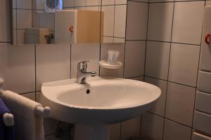 a bathroom with a white sink and a mirror at Apartma Kukč II in Bovec