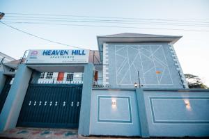 a blue building with a sign on the side of it at Heaven Hill Apartment in Arusha