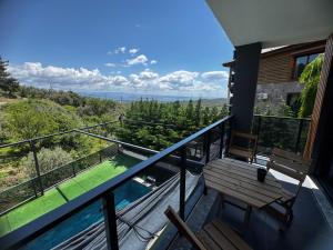 a balcony with a bench and a view of the water at Helios Kaz Dağları blok2 in Uçurumoba