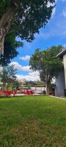 a group of red picnic tables in a park at HOSTEL FAMILIA ZANATTA in Caxias do Sul