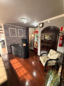 a living room with a couch and a chair at HOSTEL FAMILIA ZANATTA in Caxias do Sul
