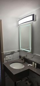 a bathroom with a sink and a mirror at South Bay Motel in Copiague