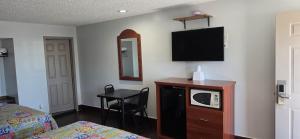 a hotel room with a bed and a tv on the wall at South Bay Motel in Copiague +15 photos