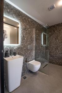 a bathroom with a sink and a toilet and a shower at Villa N&D in Ierissos