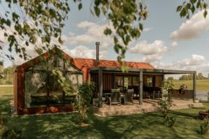 a rendering of a house with a roof at Lėtai resort, Lakefront Nature Stay with Sauna in Eželiškės