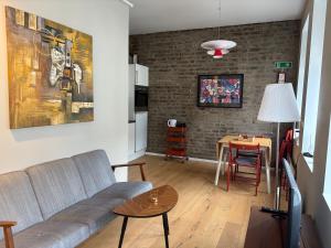a living room with a couch and a table at MB Apartments in Bergen