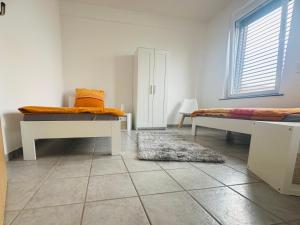 a white room with two beds and a rug at Loft im Fabrikstil mit 2 eigenen Schlafzimmern mit Wlan und Parkplatz in Groß-Umstadt