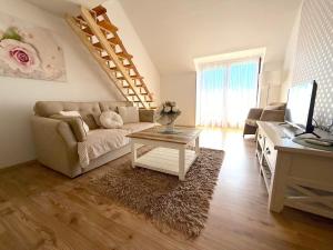 a living room with a couch and a table at Gyulai idill apartman in Gyula
