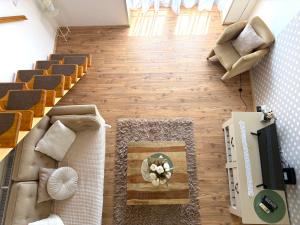 a living room with a couch and a table at Gyulai idill apartman in Gyula