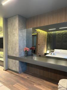 a bedroom with a bed and a large mirror at MOCCA Lux Suite in Bitola +46 photos