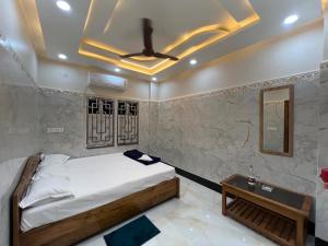 a bedroom with a bed and a ceiling fan at Jalangi Empire in mayapur +7 photos